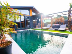 a swimming pool in front of a house at Palmera suit in Sapanca +6 photos