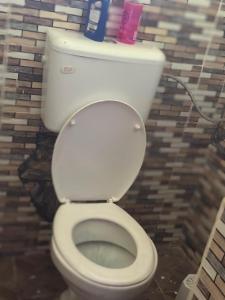 a bathroom with a white toilet in a stall at ADONAI homes in Malindi +22 photos
