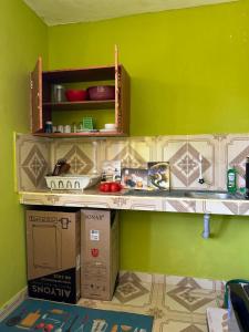 a shelf in a room with a green wall at ADONAI homes in Malindi