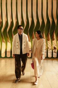 a man and a woman walking down a hallway at Lasala Plaza Hotel - Adults Only in Donostia-San Sebastián +143 photos