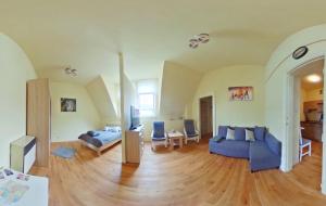 a living room with blue couches and a wooden floor at Apartamenty Marco - Stare Miasto - Super Wi Fi in Krakow