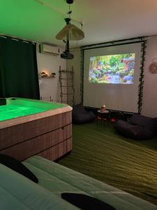 a living room with a large screen with a pool table at Ô Dream Spa in Le Val