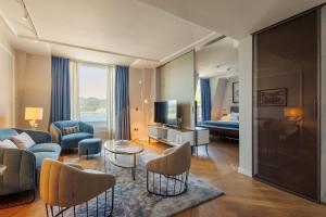 a living room with a couch and a tv at Lasala Plaza Hotel - Adults Only in Donostia-San Sebastián