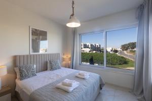 a bedroom with a bed and a large window at Mythical Blue Villas in Protaras +67 photos