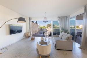 a living room with a couch and a table at Mythical Blue Villas in Protaras