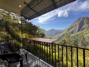 a balcony with chairs and a view of mountains at Green Mount Eye Ella in Ella