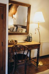 Zimmer mit einem Schreibtisch mit einer Lampe und einem Spiegel in der Unterkunft Hotel Restaurante Doña Anita in Requena