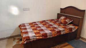 a bed with a quilt on it in a room at SPOT ON Diamond Hotel in Rāmpura