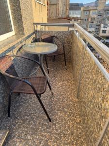 a patio with two chairs and a table on a balcony at Panorama Spa Apartment in Berehove +3 photos