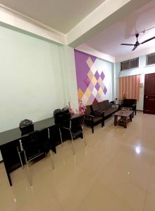 a living room with a couch and a table and chairs at Letstay in Guwahati