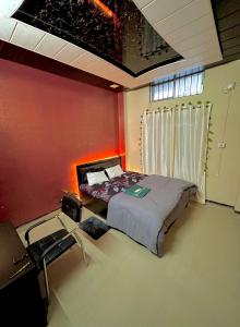 a bedroom with a bed and a table in a room at Letstay in Guwahati