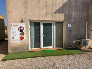 a house with a window with green grass next to it at Ô Dream Spa in Le Val