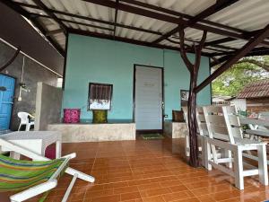 a patio with chairs and a blue wall at Banpu Beach Ao Lung Dam,Koh Samet in Ao Phutsa