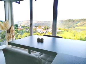 a table in a room with a large window at Apartment with panoramic view in Lipperscheid