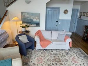 a living room with a couch and a chair at Convent Franklin - Schoolhouse Apartment in Franklin