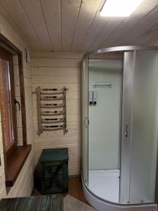 a bathroom with a shower and a stool in it at Spadok Forest Villas - Villa 2 in Sloboda +22 photos