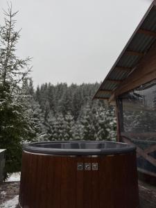 a hot tub on the side of a house with a forest at Spadok Forest Villas - Villa 2 in Sloboda