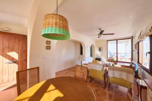 a dining room with a table and chairs and a ceiling at Rhea in San José