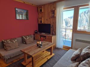 a living room with a couch and a table at Apartman Savic Jahorina in Jahorina