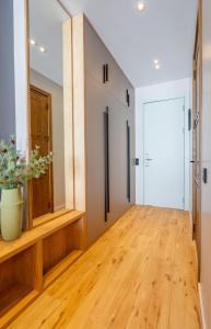 een hal met een houten vloer en een deur bij New Gudauri Atrium Apartments in Goedaoeri