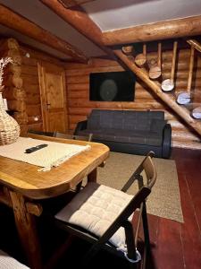 un soggiorno con un tavolo e un divano di Sunset Chalet a Ciocanu
