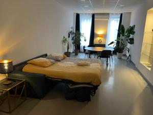 a bedroom with a bed and a table and chairs at Loft 200m2 avec écran led géant de 10m2 in Marseille