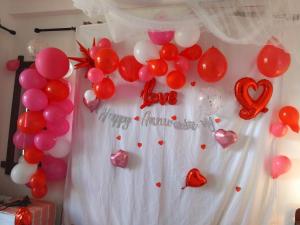 a wall with red and white balloons and hearts at Ella Hillcrest Heaven-Free Pickup from Ella in Ella