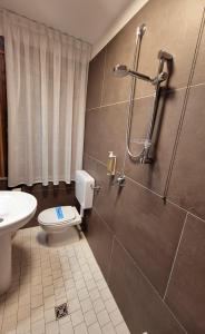 a bathroom with a toilet and a shower at The Park Hotel in Fanano +21 photos