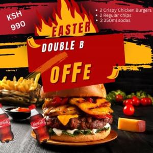 a sandwich on a plate on a table with fries at `Saala Hotel Limited in Isiolo