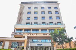 a large white building with a sasha hotel at `Saala Hotel Limited in Isiolo