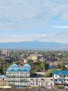 a city with buildings and mountains in the background at `Saala Hotel Limited in Isiolo +9 photos