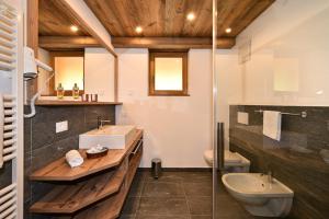 ein Badezimmer mit Waschbecken und Toilette in der Unterkunft Proihof in Villnöss