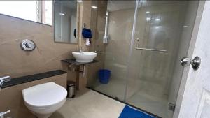 a bathroom with a shower and a toilet and a sink at Coco Villa with Private Pool in Karjat +31 photos