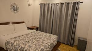 a bedroom with a bed and a shower curtain at Venus Apartment in Nairobi