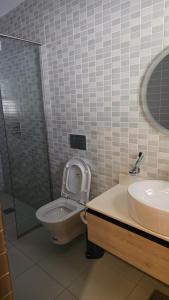 a bathroom with a toilet and a sink at Venus Apartment in Nairobi