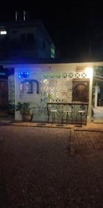 a couple of benches on a street at night at D Love Gueshouse in Ranong
