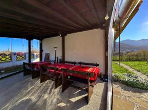 a dining room with red tables and a view at RhodoNest in Kara Agach