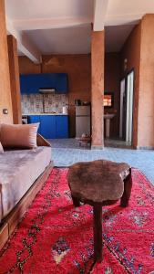 a living room with a couch and a coffee table at Atlas lodge in Sidi Hassaïn