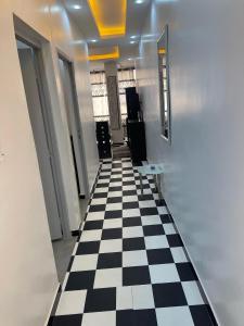 un couloir avec un sol à damier noir et blanc dans l'établissement Classimo, à Dakar