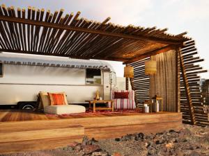 an rv is parked in a room with a table at Caravan Hatta by Our Habitas in Hatta