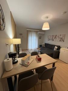a kitchen and living room with a table and chairs at G&M Home in Elassona +24 photos