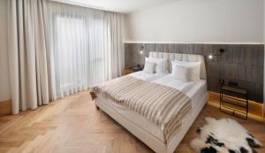 a bedroom with a large bed and a large window at Skigyimes Hotel in Lunca de Sus +23 photos