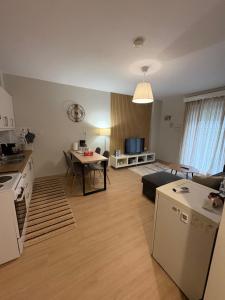 a kitchen and a living room with a table at G&M Home in Elassona