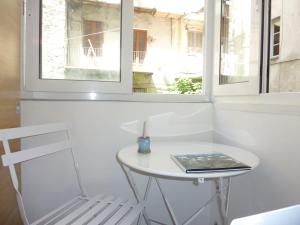a table and a chair in a room with a window at Studio meublé Centre ville in Bastia