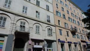 a large building with an archway in front of it at Studio meublé Centre ville in Bastia