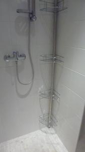 a shower with three wire baskets in a bathroom at Studio meublé Centre ville in Bastia