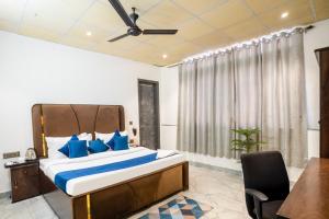 a bedroom with a large bed with blue pillows at Bnb Sakura , Golf Course Road in Gurgaon