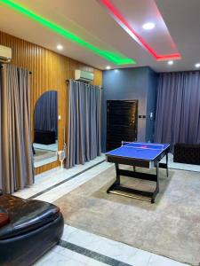 a gaming room with a ping pong table in it at Boho apartment and spa in Lekki