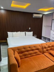 a bedroom with a large bed and a couch at Boho apartment and spa in Lekki
