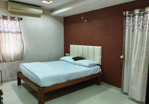a bedroom with a bed in a room at Geetha Residency in Anantapur
